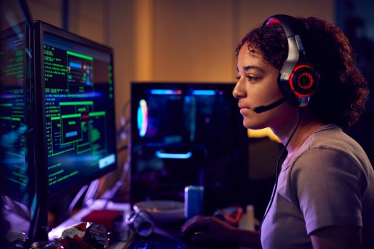 female-teenage-hacker-sitting-in-front-of-computer-screens-bypassing-cyber-security.jpg